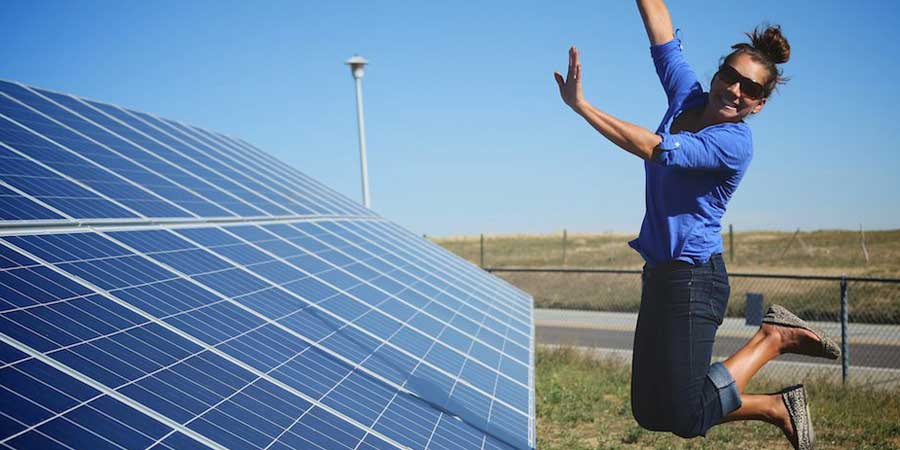 solar panels woman jumping happy